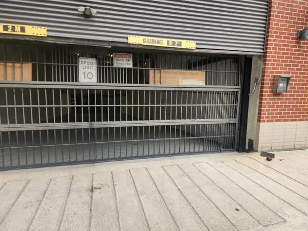 Rolling security grille closing off a parkade entrance from the street