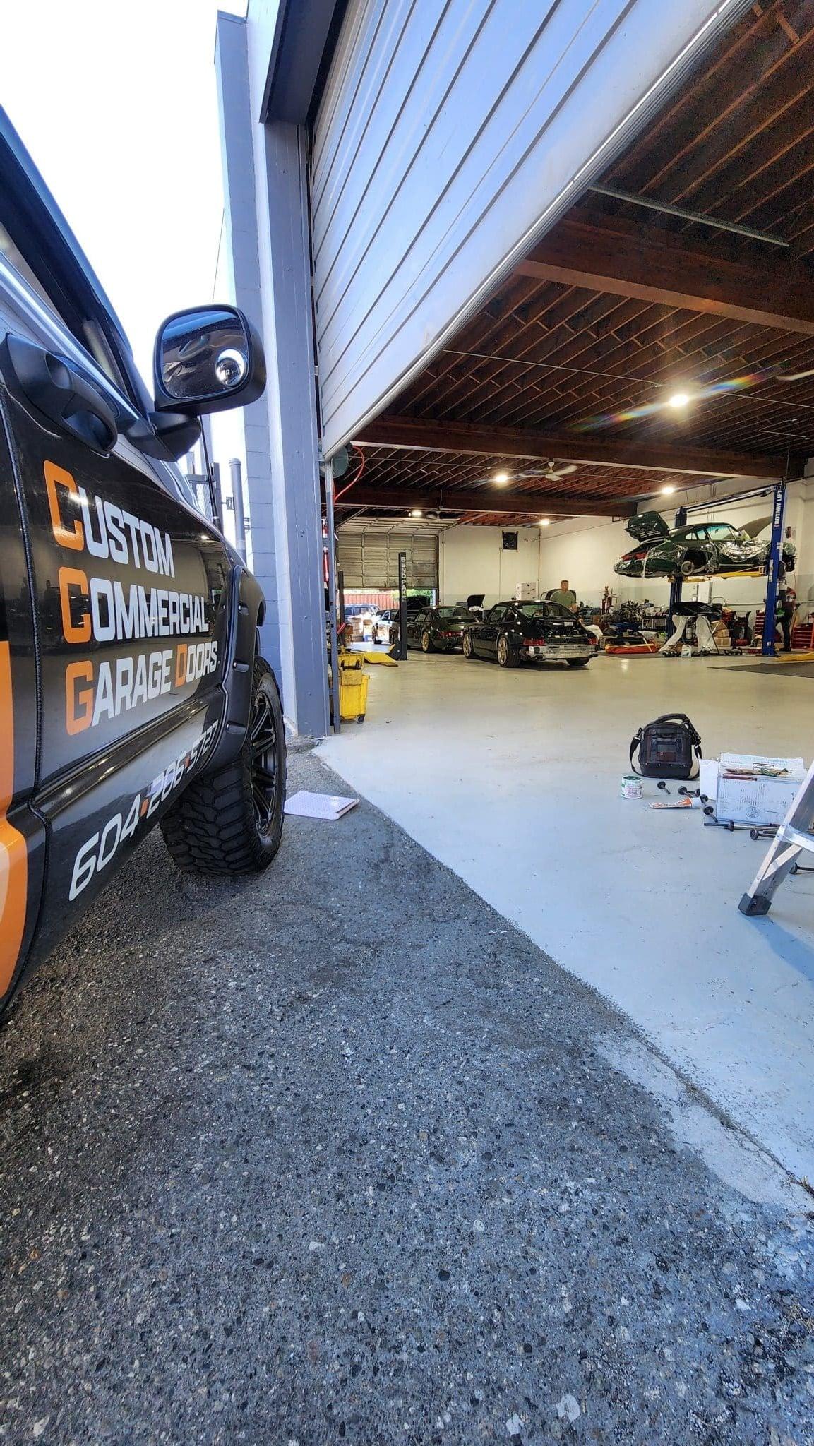 "Commercial garage door repair at Mike Auto in Richmond, BC, specializing in Porsche and exotic car facilities