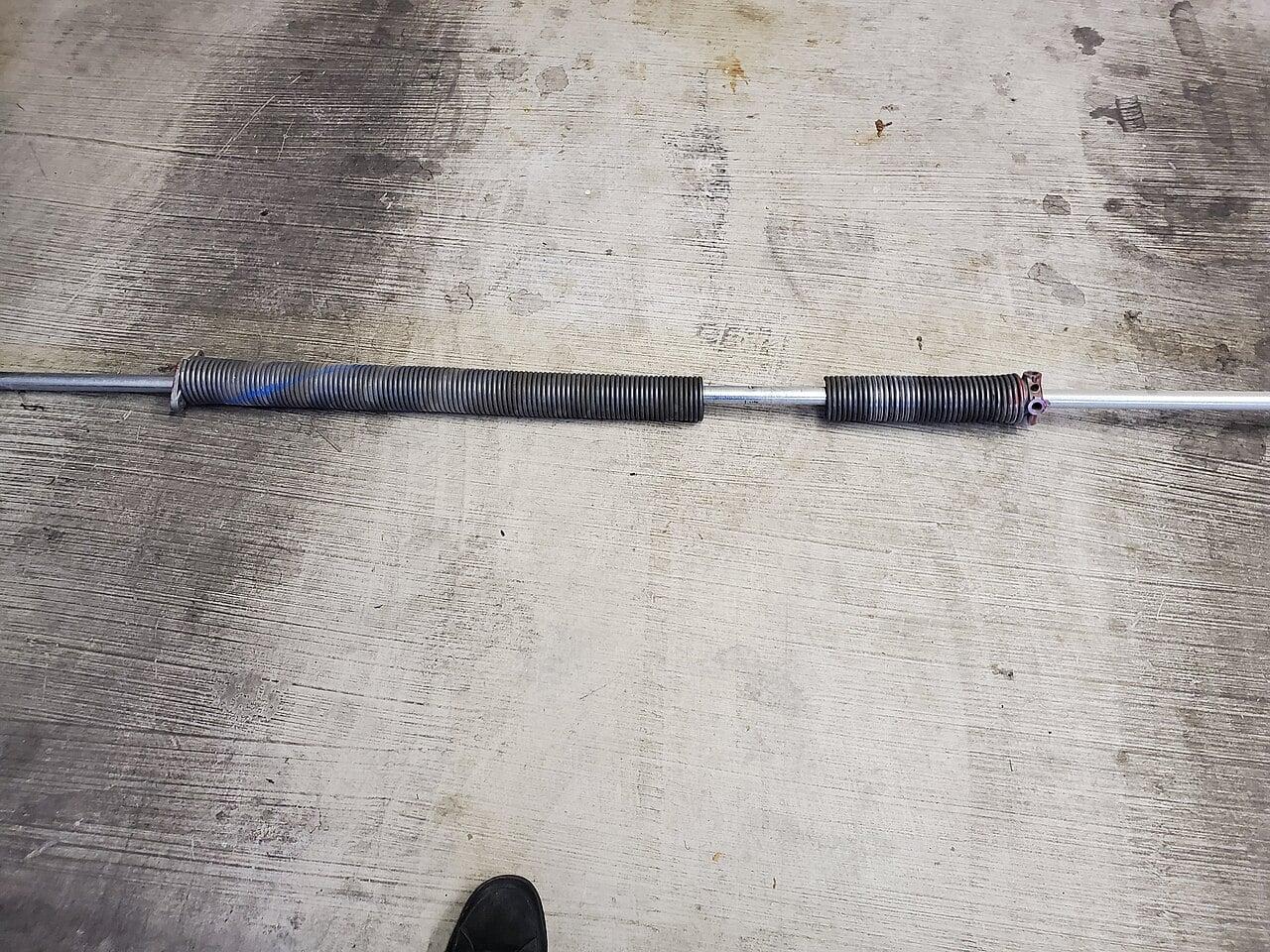 Commercial torsion spring assembly above garage door — CCGDS Vancouver