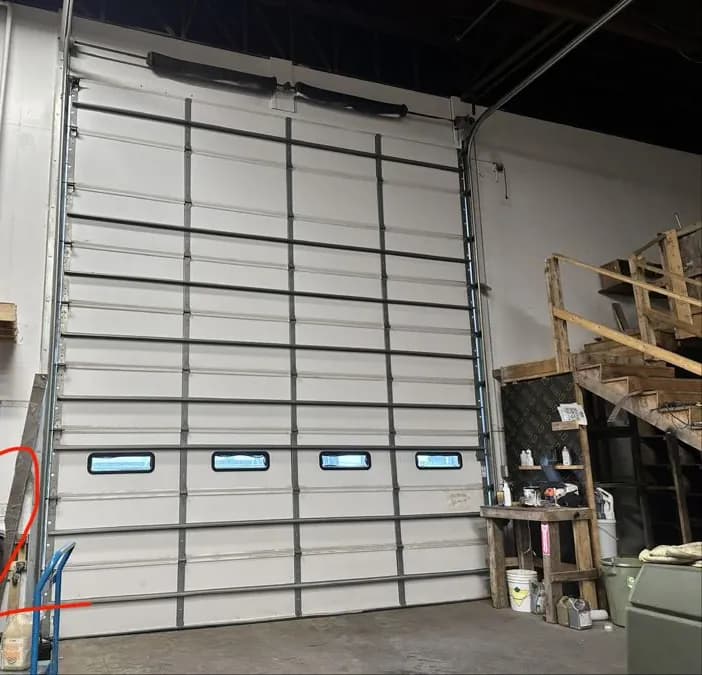 Insulated warehouse sectional door with vision windows
