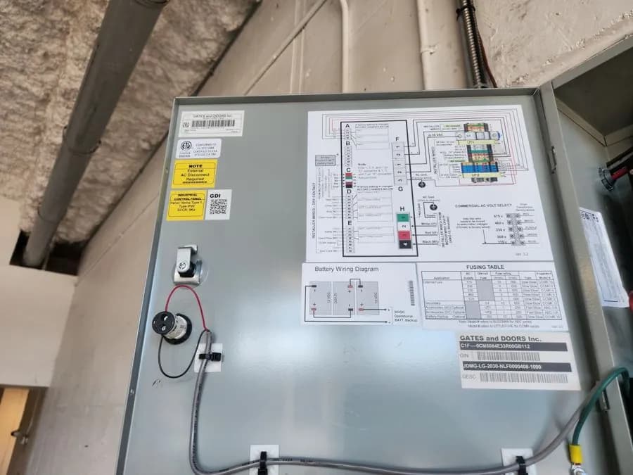 Commercial door operator control panel opened for service