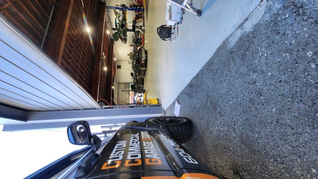 "Commercial garage door repair at Mike Auto in Richmond, BC, specializing in Porsche and exotic car facilities