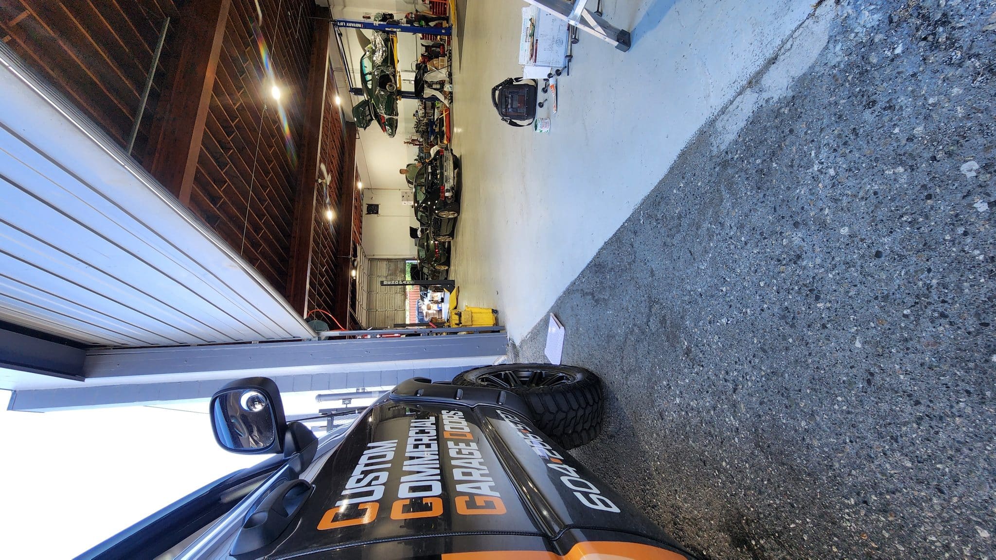 "Commercial garage door repair at Mike Auto in Richmond, BC, specializing in Porsche and exotic car facilities